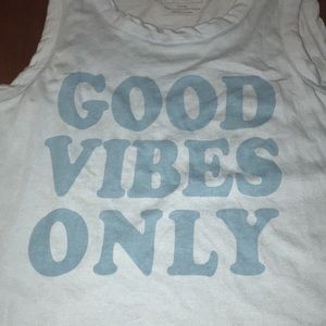 It’s a sky blue tank top that’s says “good vibes only” in round letters